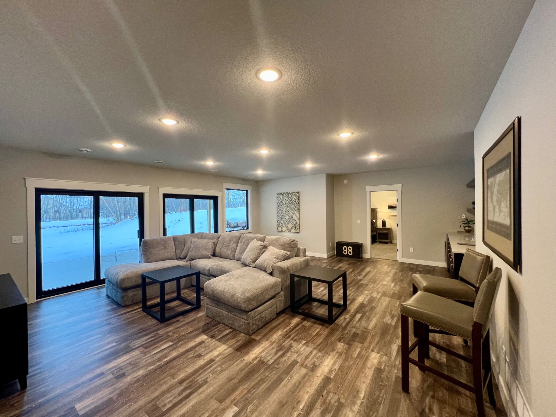 Sectional sofa facing sliding doors to the lower terrace.