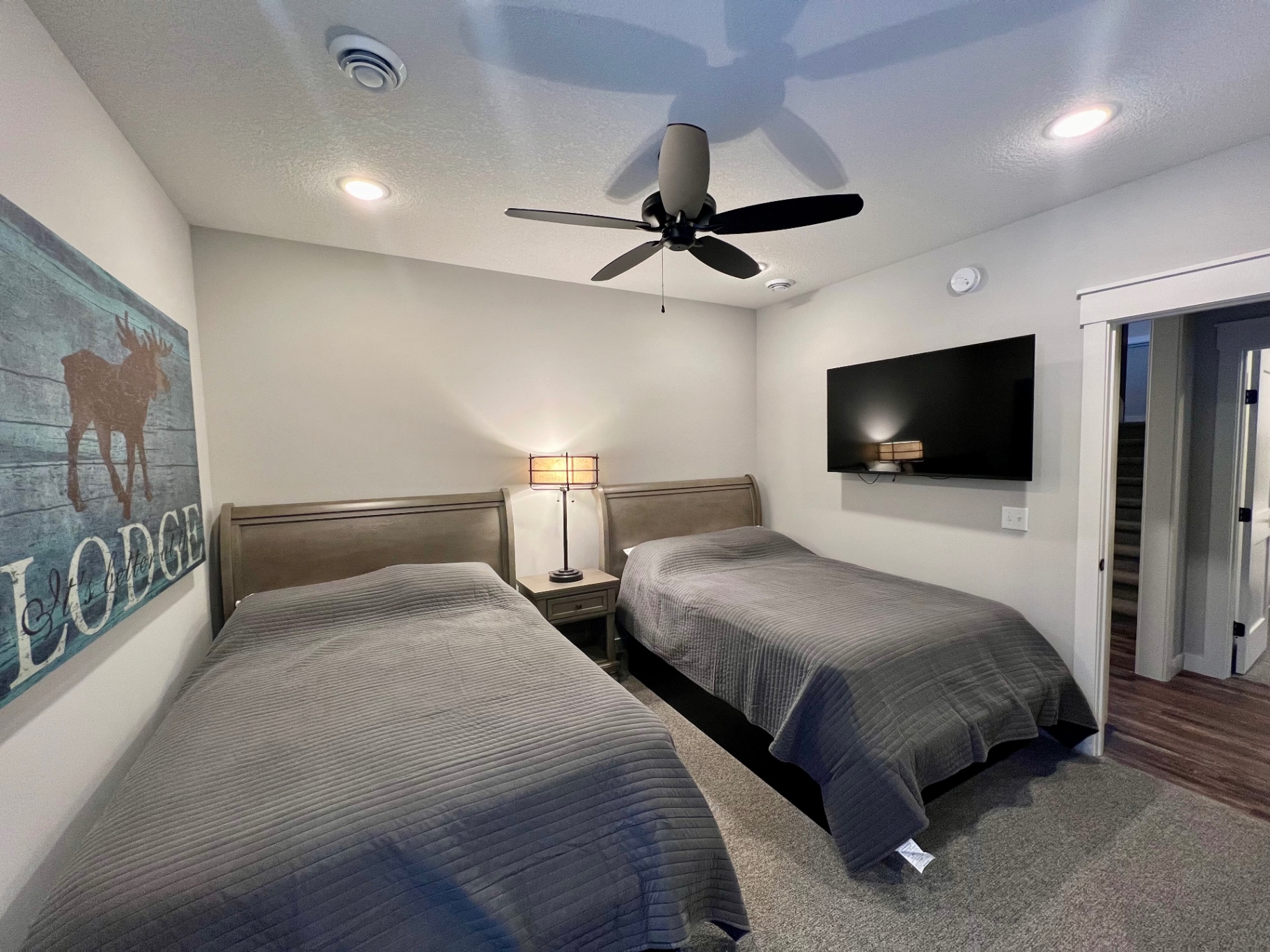 Two beds with mounted TV.